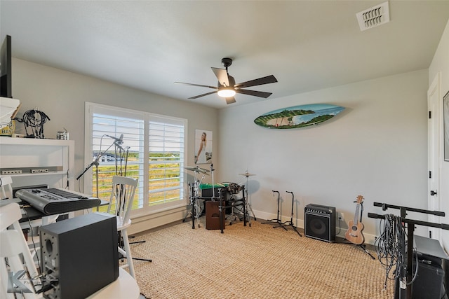 office space with ceiling fan, carpet, visible vents, and baseboards