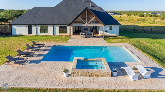 exterior space with a yard, a pool with connected hot tub, a patio area, ceiling fan, and a fenced backyard