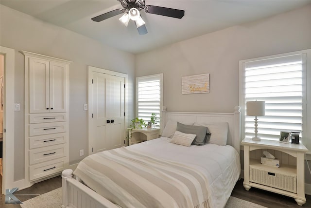 bedroom featuring a closet, dark wood finished floors, and a ceiling fan