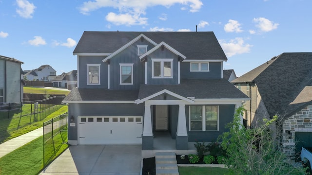 craftsman house with a front yard and a garage