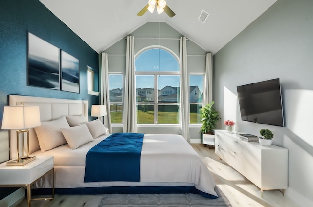 bedroom featuring ceiling fan, high vaulted ceiling, and wood-type flooring