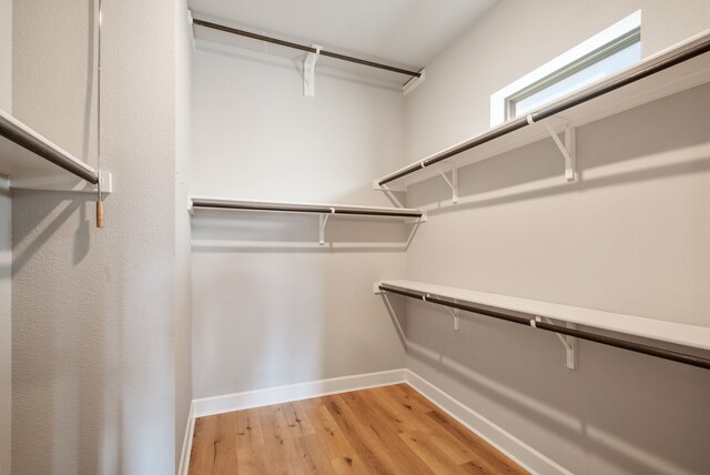 spacious closet with light hardwood / wood-style floors