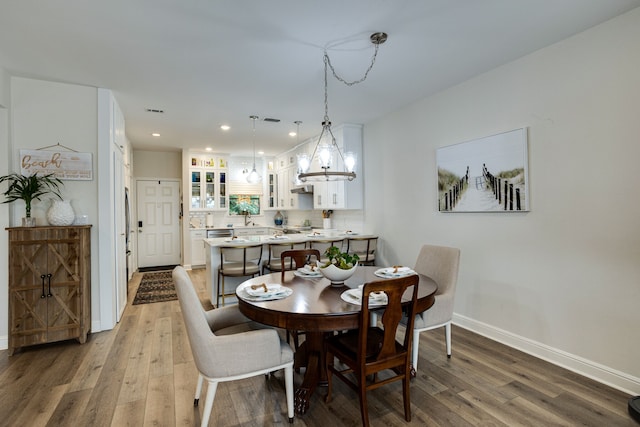 dining space with hardwood / wood-style floors