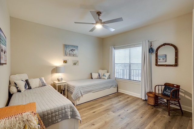 bedroom with light wood-type flooring and ceiling fan