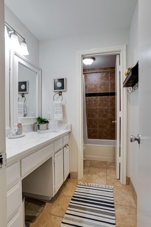 full bathroom with tile patterned flooring, vanity, tiled shower / bath combo, and toilet