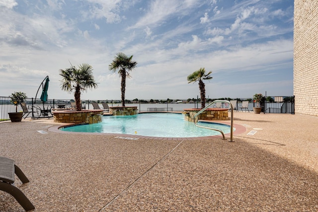 view of swimming pool featuring pool water feature and a patio area