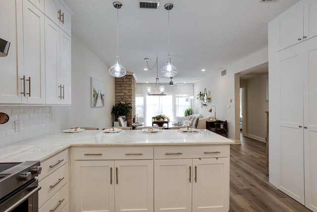 kitchen with pendant lighting, stainless steel electric stove, dark hardwood / wood-style floors, light stone counters, and white cabinetry