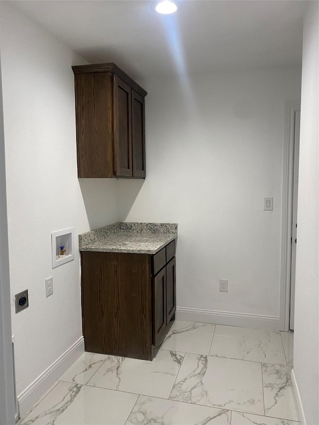 laundry room featuring electric dryer hookup, cabinets, and washer hookup