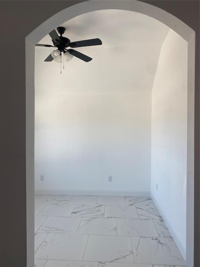 empty room featuring ceiling fan and lofted ceiling