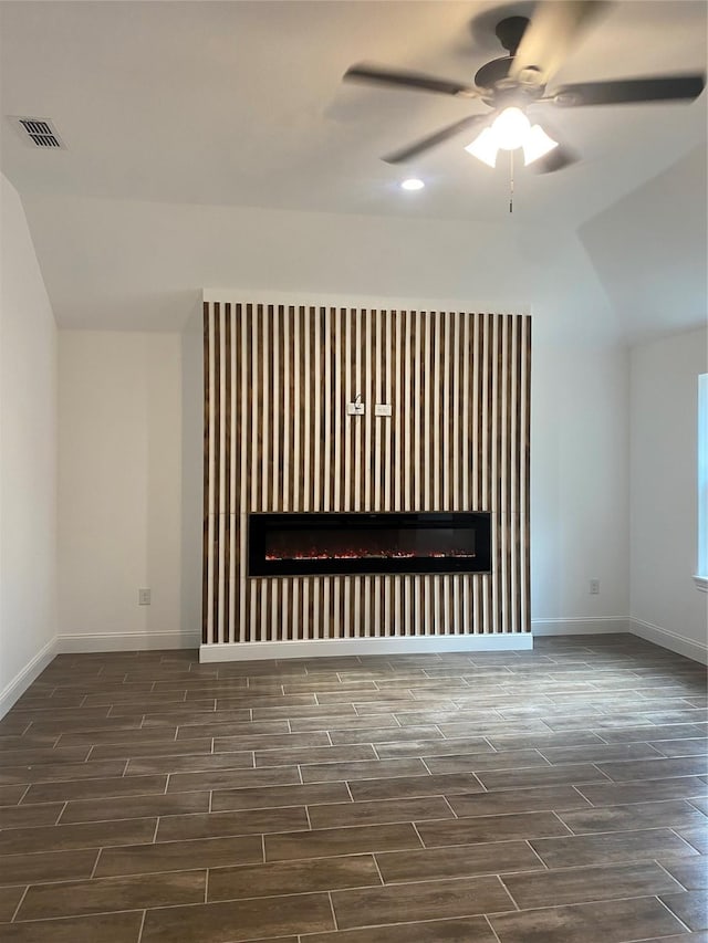 unfurnished living room featuring vaulted ceiling and ceiling fan