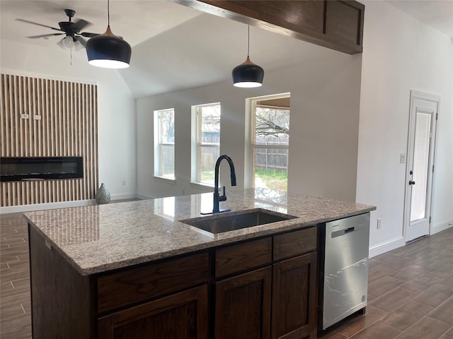 kitchen with light stone countertops, sink, ceiling fan, stainless steel dishwasher, and pendant lighting