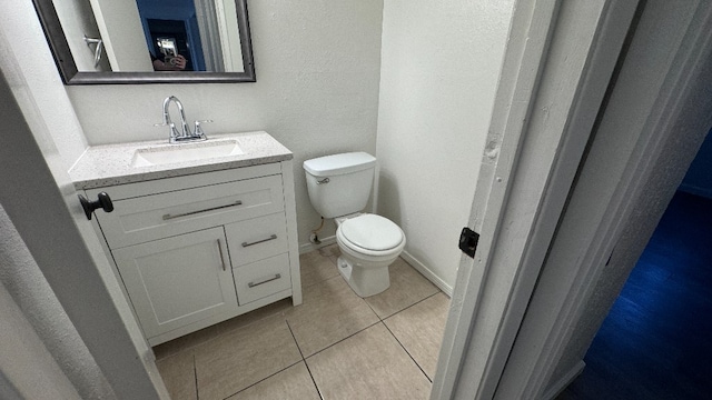 bathroom with tile patterned floors, vanity, and toilet