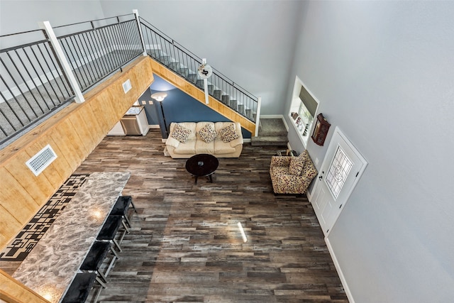 interior space with a high ceiling and dark hardwood / wood-style flooring