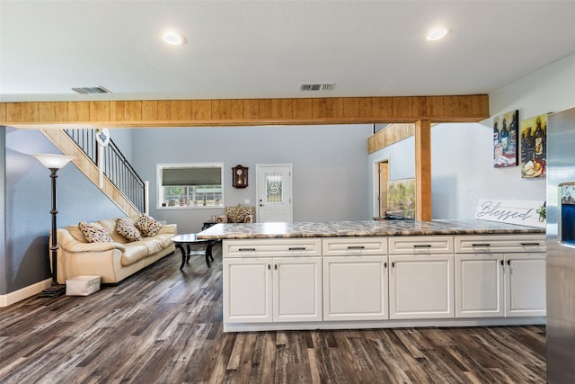 kitchen with stainless steel fridge, white cabinetry, dark hardwood / wood-style flooring, and stone counters