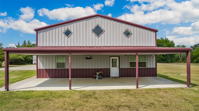 farmhouse inspired home with a patio area, board and batten siding, and a front lawn