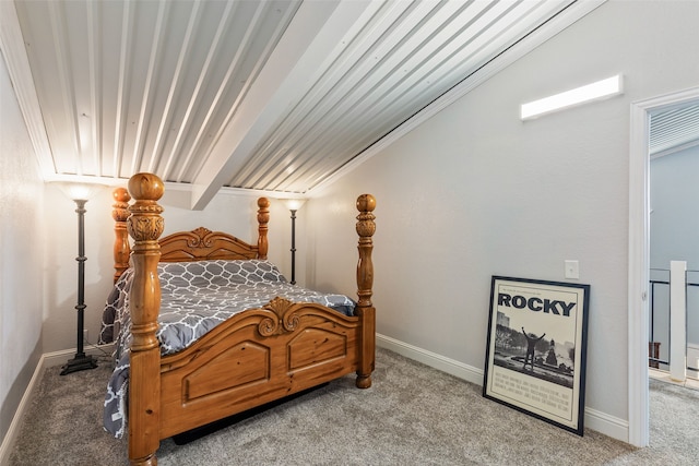 carpeted bedroom with beamed ceiling and ornamental molding