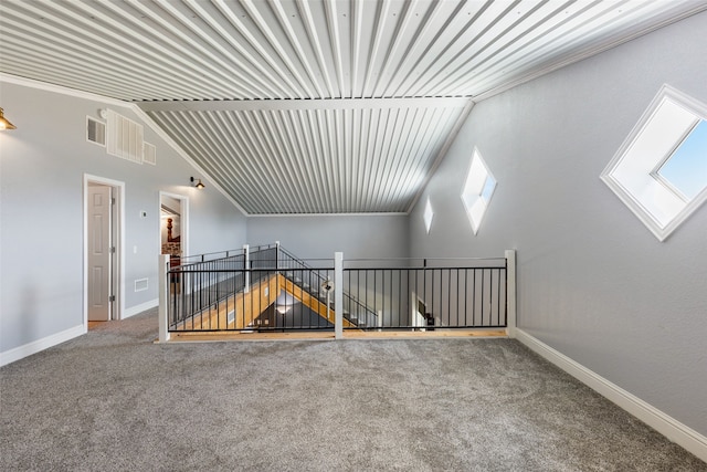 additional living space with carpet flooring and a skylight