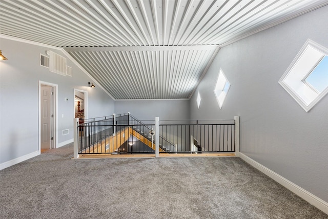 additional living space featuring vaulted ceiling, visible vents, baseboards, and carpet floors