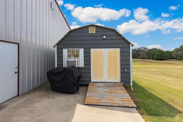 view of outdoor structure featuring a lawn