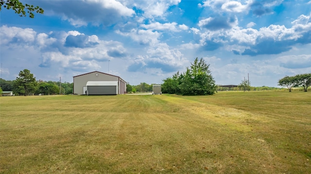 view of yard with an outdoor structure and a garage