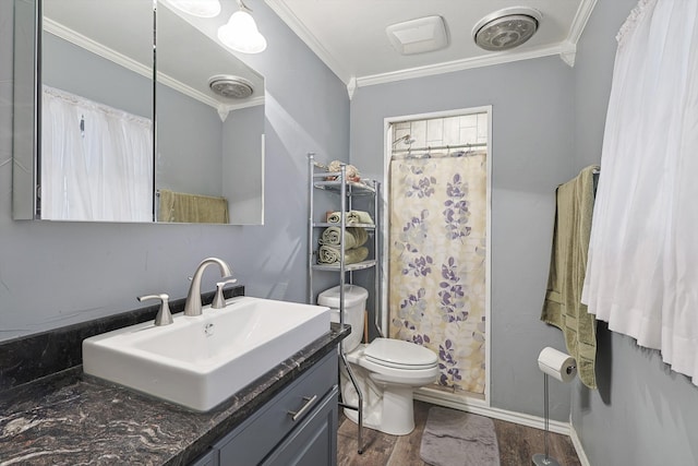 bathroom featuring ornamental molding, wood-type flooring, curtained shower, vanity, and toilet