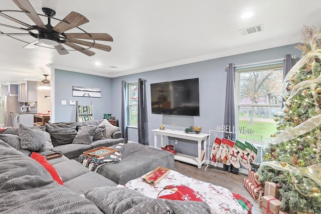 living room with ceiling fan, hardwood / wood-style flooring, and ornamental molding