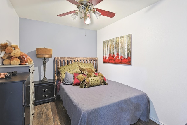 bedroom with ceiling fan and dark hardwood / wood-style flooring