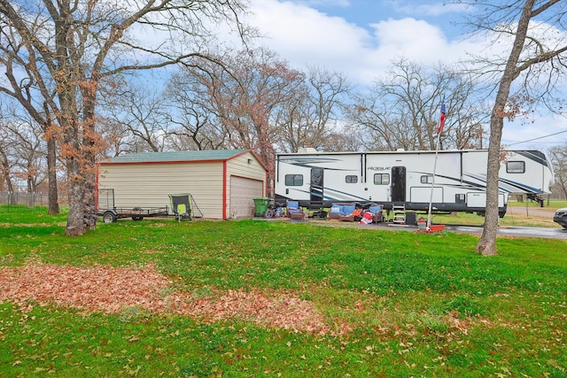 exterior space featuring a garage and an outbuilding