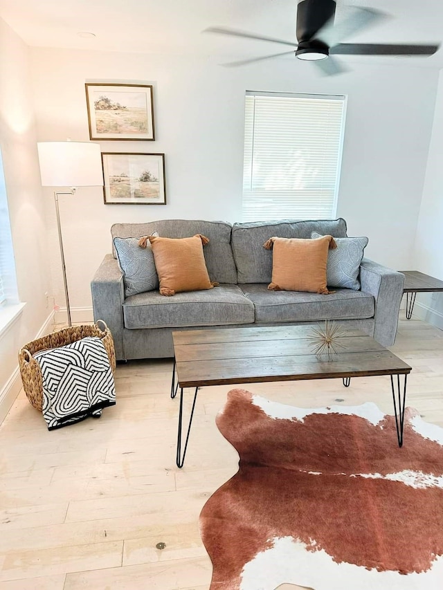 living room featuring hardwood / wood-style flooring, ceiling fan, and a healthy amount of sunlight