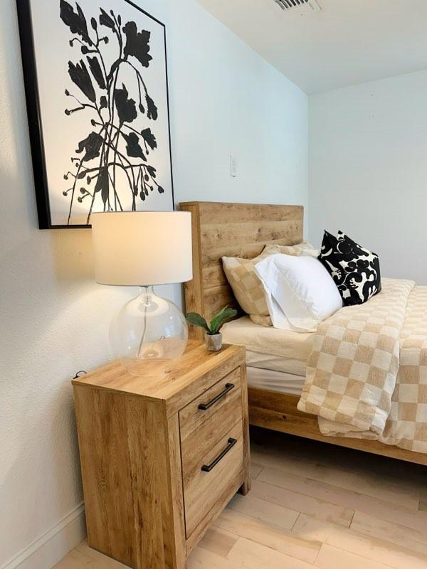 1118 E Oak St, Denton, TX 76205 - bedroom with light wood-style floors and baseboards