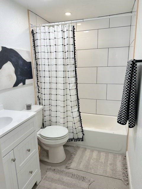 full bathroom with shower / bath combo with shower curtain, toilet, and vanity