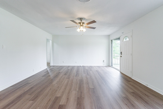 empty room with ceiling fan and wood-type flooring