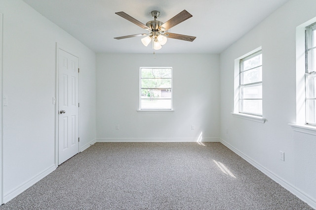 spare room with ceiling fan and carpet