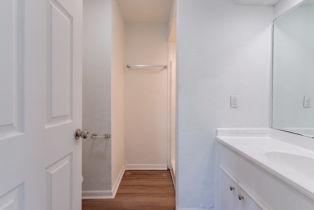 bathroom with hardwood / wood-style floors and vanity