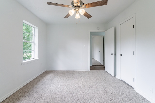 unfurnished bedroom featuring ceiling fan and carpet flooring