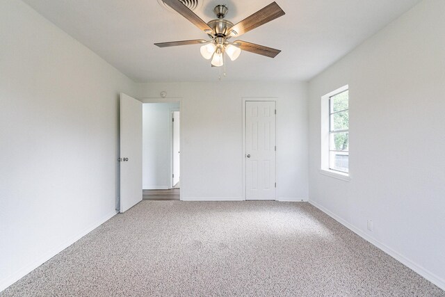 unfurnished bedroom featuring ceiling fan, a closet, and carpet