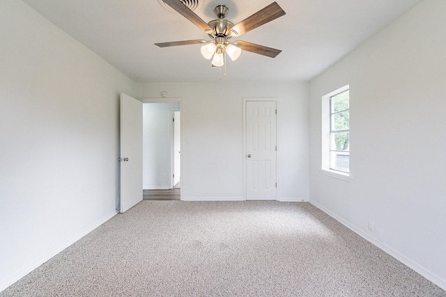 unfurnished bedroom with carpet floors, baseboards, and a ceiling fan