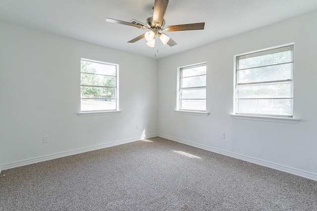 unfurnished room featuring baseboards, ceiling fan, carpet flooring, and a healthy amount of sunlight