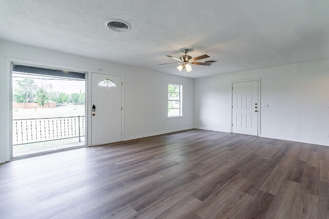 foyer with ceiling fan, hardwood / wood-style flooring, and a textured ceiling