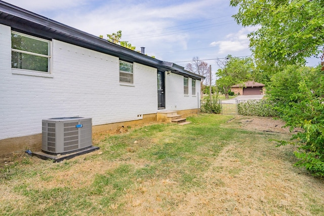 view of yard featuring entry steps and central air condition unit