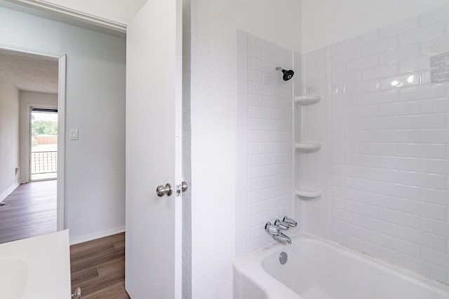 bathroom featuring hardwood / wood-style flooring and tiled shower / bath