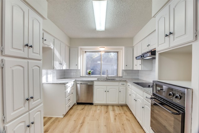 kitchen with white cabinetry, sink, and black appliances