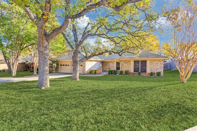 single story home featuring a garage and a front lawn