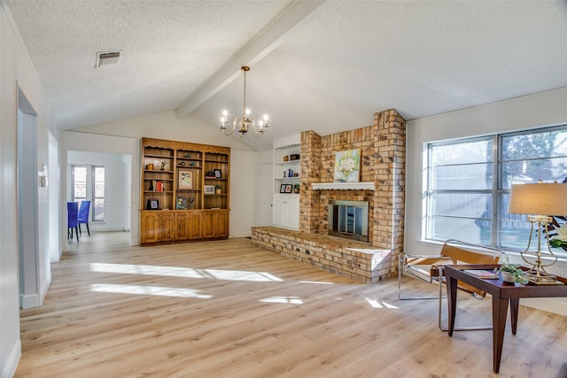 living room with plenty of natural light, lofted ceiling with beams, and light wood-type flooring