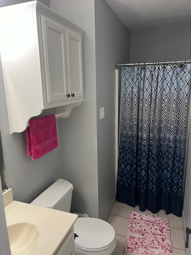 bathroom with tile patterned flooring, vanity, a shower with curtain, and toilet