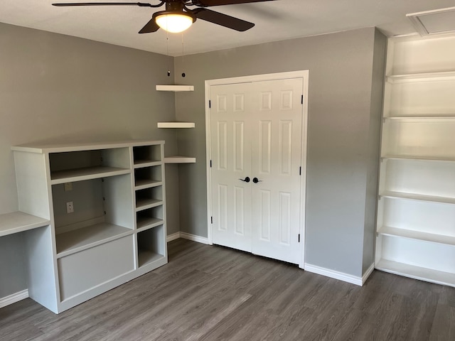 unfurnished bedroom with ceiling fan, dark hardwood / wood-style floors, and a closet