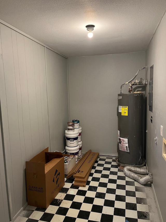 utility room featuring water heater and electric panel