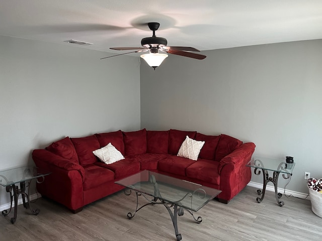 living room with ceiling fan and wood-type flooring