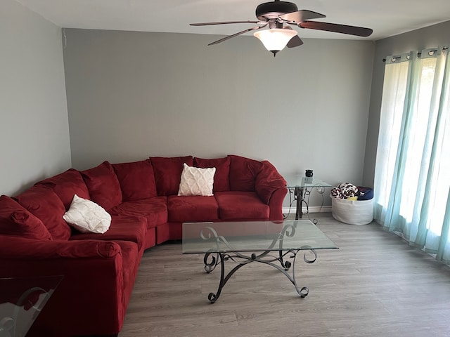 living room with light hardwood / wood-style floors and ceiling fan