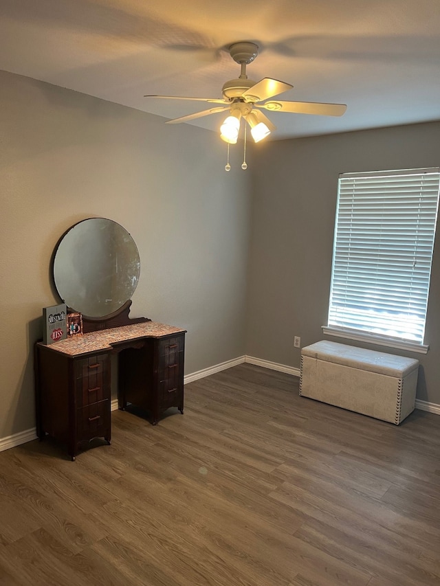 unfurnished office with ceiling fan and wood-type flooring